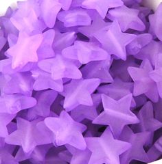 a bowl filled with purple stars on top of a table