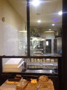 a counter with some food on it in front of a glass door that is open