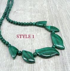 "Genuine Malachite gemstone beaded necklace, made of dark green stone beads in round and leaf shapes. Natural malachite jewelry, dainty bib necklace. Length: from 18 and 19 \" ( 46 and 48 cm ) - can be shortened on request. Beads: 4 mm balls and leaves measuring from 15 to 30 mm long. Please see all photos and select the style: Style 1 - the necklace with wider spread leaves, 19 inches long. Style 2 - the necklace with darker leaves placed closer together and making more V-shape, 18 inches long. Malachite Gemstone Bead Necklaces, Malachite Gemstone Beads Necklace, Green Onyx Round Beads Jewelry, Green Oval Polished Beads Jewelry, Polished Malachite Round Beaded Necklaces, Green Oval Beads Necklace In Spiritual Style, Handmade Green Oval Beads Jewelry, Green Oval Beads Necklace With Spiritual Style, Round Malachite Beaded Necklace