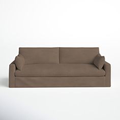 a brown couch sitting on top of a white floor