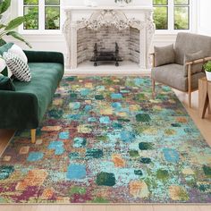 a living room filled with furniture and a colorful rug on top of a hard wood floor