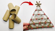 an origami christmas tree made out of toilet paper and rolled up with red beads