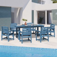 a blue table and chairs next to a swimming pool