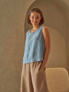 "PRODUCED in 3-5 days FAST & FREE shipping with DHL Express Courier -10% for all items with code \"FAVOURITE\" A sleeveless linen top with a slightly longer back in a subtle steel blue hue is a true charm to any outfit. Cropped waist and relaxed fit will give you comfort on breezy summer days. You can wear the top in colder seasons too by layering it with warm knitwear and trousers.  Details: - 100% Linen - Round neck - Slightly boxy fit - Cropped waist length - Model's height is 160 cm / 5'3'' wears size M - Code: E5002-L532 -126 The top is available in other colors. You can find them in the gallery. If you want to order the top in another color, please specify it in the personalization field. Sizing: This garment is true to size, and we recommend choosing the size you usually wear. If yo Blue Cropped Vest For Summer, Casual Sleeveless Flax Tank Top, Sleeveless Flax Tops For Spring, Flax Sleeveless Top For Spring, Spring Sleeveless Flax Tops, Spring Flax Sleeveless Top, Blue Cropped Vest For Spring, Sleeveless Linen Crop Top For Spring, Sleeveless Flax Summer Tops