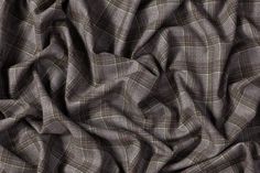 the fabric is made up of grey and green plaid