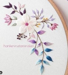 an embroidery project with flowers and leaves on it