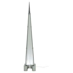 a tall metal pole with a light on it's side and a white background