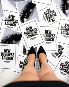 a woman's legs surrounded by new business launch flyers and false lashes on the floor