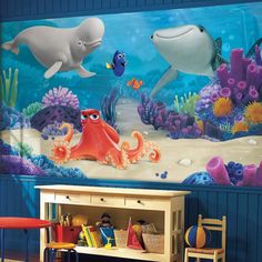 an ocean scene with dolphins and octopuses painted on the wall