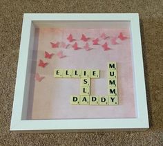 scrabble tiles spelling the word'mum is my daddy'with pink butterflies