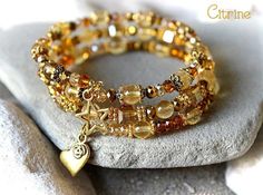 Citrine Bracelet, Citrine Wrapped Bracelet, Citrine and Gold Bracelet, Citrine Jewelry, Yellow Bead Bracelet, Citrine Multistrand Bracelet, Citrine Cuff Bracelet, Birthstone Bracelet, November Bracelet Gorgeous energy bracelet made of 6 mm. Citrine beads, gold crystals and gold plated components. The beads are strung on hard memory wire in 3 rows. This bracelet is adjustable. See the last photo and choose your size spiral wire with the option. ♥ Unique design & handmade product by MimosaMile Luxury Round Citrine Bracelets, Adjustable Gold Citrine Crystal Bracelet, Gold Citrine Round Beaded Bracelets, Gold Citrine Beaded Bracelets With Round Beads, Gold Bohemian Crystal Bracelet With 8mm Beads, Gold Citrine Round Beads Crystal Bracelet, Gold Crystal Bracelet With Gemstone Beads As Gift, Gold Crystal Bracelet With Gemstone Beads For Healing, Gold Hand-strung Crystal Bangle Bracelet