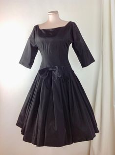 1950's Black Taffeta Cocktail Dress with a fitted bodice and a drop waist, a full pleated skirt, square cut-out neckline.. Wow. Such a beautiful dress!! There is a metal zipper that runs down the back of this dress for that perfect tailored hourglass fit. This garment is in EXCELLENT VINTAGE CONDITION. There are no stains, holes, repairs or snags. *There is no fashion label in this dress. There is a size label that is marked size 14.. lol.. ( of course this is sizing from the 1950's, and in toda Retro A-line Vintage Dress For Formal Occasions, Classic Vintage Dress With Fitted Bodice For Formal Occasions, Formal Dresses With Accordion Pleats And Full Skirt, Formal Full Skirt Dress With Accordion Pleats, Fitted Black Dress With Gathered Skirt, Black Fitted Dress With Gathered Skirt, Accordion Pleated Full Skirt Party Dress, Evening Dress With Accordion Pleats And Full Skirt, Fitted Dress With Pleated Waist And Square Neck