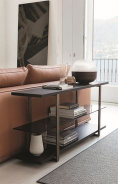 a living room with a couch, coffee table and pictures on the wall