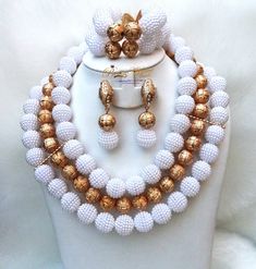 White with Gold Balls Wedding Bridal Party African Nigerian Beads Jewelry Set Complete Set is Necklace Earring and bracelet **Beads is acrylic  Wedding Party Bridal Special Occasion This detailed Jewellery set makes you stand out elegantly in any special occasion, it's all about glamour and uniqueness.  Buying more than 1 Jewellery set, we offer wholesale and bulk prices for all our jewellery. White Crystal Bridal Sets For Party, Elegant White Bridal Sets For Party, White Round Jewelry Sets For Party, Pearl White Jewelry With Gold Round Beads, White Polished Beads Round Jewelry, White Polished Round Beads Jewelry, Elegant White Pearl Bridal Sets, Party Pearl White Beaded Bracelets With Round Beads, White Pearl Beaded Necklaces With Gold Beads