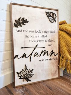 a wooden sign that reads and the sun took a step back, the leaves pulled them themselves to sleep and autumn was awaked