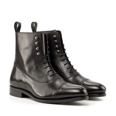 a pair of black leather boots on a white background