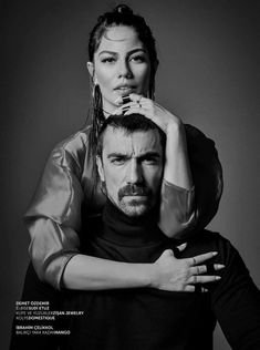 a black and white photo of a woman sitting on top of a man's head