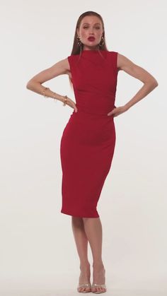 a woman in a red dress posing for the camera with her hands on her hips