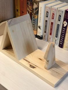 a book shelf with books and a wooden house