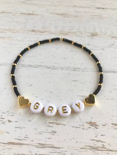 🔹This is a delicate bracelet customized with a name/word/saying of your choosing. It is made with 24k gold plated tiny hearts, Japanese Miyuki glass seed beads in white or black and white acrylic beads with gold letters and then strung together with a strong elastic cord. They are beautiful to wear alone or to layer with other jewelry and are perfect for yourself or for a gift. 🔹Each dainty stackable item is packed in a beautiful organza bag and a handwritten message can also be included. It m Inspirational Personalized Beaded Bracelets For Birthday, Custom Text Beaded Bracelets With Round Beads For Friendship, Customized Inspirational Beaded Bracelets With Adjustable Fit, Adjustable Beaded Charm Bracelet For Personalized Gift, Customized Adjustable Inspirational Beaded Bracelets, Customized Inspirational Adjustable Beaded Bracelets, Customizable Adjustable Inspirational Beaded Bracelets, Inspirational Customized Adjustable Beaded Bracelets, Adjustable Beaded Bracelets With Custom Text For Gifts