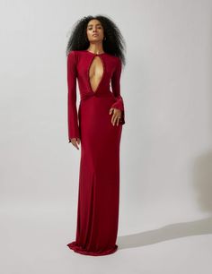 The flared long sleeves add a touch of drama and elegance to the silhouette, enhancing the overall allure of the gown. The front bust features a tasteful cut, adding a subtle hint of allure and intrigue to the ensemble. Meanwhile, the low deep back cut creates a mesmerizing focal point, exuding confidence and grace. The Low, Focal Point, Overalls, Drama, Long Sleeves, Confidence, Long Sleeve