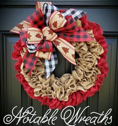 a wreath with burlocks and plaid bows hanging on the front door for fall