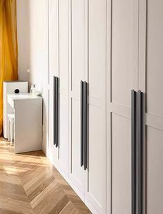 an empty room with white cabinets and yellow curtains