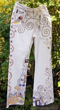 Inspired from the famous Austrian artist Gustav Klimt, the Doodled Denim images are hand drawn with fabric marker.  These Doodled Denims were so much fun to create, being a big fan of  Art Nouveau.   These pre-loved jeans were made by Nevada, have a Boot Cut cut leg and list a size of 10.  However, please review our own measurements and read the measurements information to ensure an accurate fit, as jean sizes vary greatly across designers.  These jeans have no stretch.  Measurements:  Waist=31i White Embroidered Cotton Jeans, White Cotton Jeans With Graphic Print, Artistic Cotton Jeans For Summer, Artistic Cotton Bottoms With Graphic Print, Artsy Cotton Jeans For Spring, Casual Hand Painted Cotton Bottoms, Fashion Over 50 Fifty Not Frumpy, Plus Size Clothing Stores, Fashion Preppy