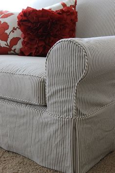 a striped chair with red and white pillows