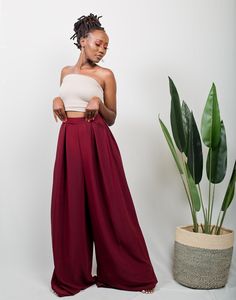 The TULIPS Palazzo pants can easily transition from an office look to a casual look depending on how you style them. Pair them up with a pair of heels & a blazer to achieve an official look. Transition to a casual look by throwing in a bandeau top and sneakers/ sandals. Made from polyester fabric. The pants measure 47 inches/ 119 cm from the waist. The model is wearing a UK 6/ XS. She is 5'6 / 171cm tall. The pants have pockets on both sides. Colour: Dark Maroon * Made in Kenya with 🧡 SIZE GUID Casual Business Wide-leg Pantsuit, Casual Straight Pantsuit For Night Out, Casual High-waisted Pantsuit For Night Out, Casual High Waist Business Casual Pantsuit, Chic Wide Leg Dress Pants For Day Out, Elegant Wide Leg Dress Pants For Day Out, Elegant Wide Leg Pants For Fall Day Out, Elegant Wide-leg Dress Pants For Day Out, Chic Tailored Bottoms For Day Out