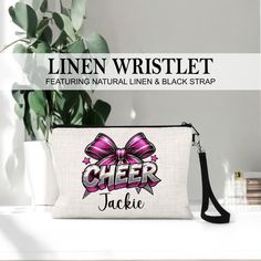 a white bag with a pink bow on it and the words cheer jackie written in black