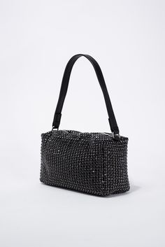 Introducing the Betsy Rhinestone Evening Bag. This elegant and stylish bag features stunning rhinestone detailing, adding a touch of glamour to any outfit. With its compact size, it's perfect for carrying all your evening essentials. Elevate your look and make a statement with the Betsy Rhinestone Evening Bag. SizeH: 5"W: 7.5"D: 2.75" QualityMade with quality Materials for endurance. ImportedBAG12254 Glamorous Square Shoulder Bag, Trendy Rhinestone Evening Bag For Night Out, Trendy Rhinestone Clutch Shoulder Bag, Evening Black Bags With Rhinestone Rivets, Trendy Rhinestone Bags For Party, Trendy Rhinestone Clutch Bag, Trendy Party Bags With Rhinestones, Black Rhinestone Bags For Night Out, Chic Rhinestone Evening Bag For Night Out