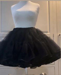 Handmade, made to order, black dress net vintage style,circle skirt style.Available in UK clothing size. Small 10-12, medium 12-14, large 16-18, and X-Large size 20-22.The length is above- the-knee. The waistband has an elastic inside. washable with matching delicate colours. The length is 40cm(16")with 3 layers of dress net,each consisting of 2 tiers,and a soft polyester material underskirt. Edged in a delicate black bias trim.Ideal for the festive season too! Ideal present for your wife, girlf Black Ruffled Petticoat For Summer, Summer Black Ruffled Petticoat, Black Full Skirt Petticoat For Wedding, Black Crinoline Full Skirt Petticoat, Black Full Skirt Crinoline Petticoat, Black Summer Petticoat For Costume Party, Black Tiered Skirt Petticoat For Wedding, Black Ruffled Full Skirt Petticoat, Black Crinoline Petticoat For Wedding