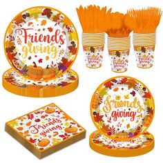 a set of thanksgiving dinnerware with orange and white plates, napkins, and cups