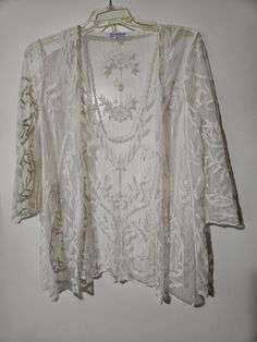 An airy open front very elegant sheer overlay jacket.  This lovely sheer jacket has a beautiful all over embroidery with 3/4 sheer sleeves and scalloped trim.  This can definitely be dressed up or down.   Thank you kindly for visiting SGI! Please check out other items listed on our site. https://www.etsy.com/shop/ShesgotitbySky Spring Wedding Lace Outerwear, Summer Wedding Long Sleeve Outerwear, All Over Embroidery, Sheer Jacket, Mesh Jacket, Floral Overlay, Sheer Overlay, Scalloped Trim, Sheer Sleeves