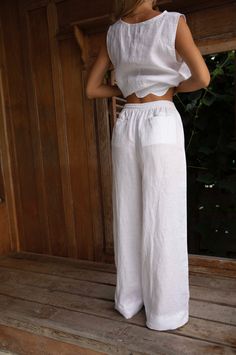 The Lottie Linen Pants feature an elasticised waist with a drawcord, side and back pockets, and a relaxed wide leg. Styled here with our cropped Nat top and scolloped Roma Top. Features Side PocketsElasticised wide waistband with frill hemWide LegsCropped LengthDesigned to be worn mid waistWorn here with the linen IBIZA Tube Top Fabric Pure Linen Cold gentle machine wash. Do not tumble dry. Colours Black Linen Natural Linen Natural Stripe (this fabric is COTTON) White Linen (*white linen not lin Bath Wedding, Womens Dress Tops, Homewear Woman, Studio Color, White Linen Pants, Linen Shirt Men, Linen White, Outdoor Home, Photographic Studio