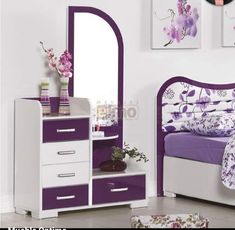 a purple and white bedroom with flowers on the bed, dresser and mirror in it