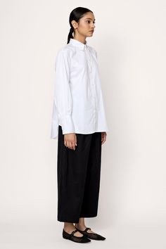 Introducing our timeless Museo Button-Up, inspired by classic menswear designs. Crafted from premium organic cotton poplin with a soft washer finish, this shirt embodies relaxed elegance. Its loose fit is complemented by curved hems at the front and back, along with a single box pleat at the back yoke for added sophistication. Wear it tucked into our Boyfriend Trouser for a polished look, or pair it effortlessly with our Barrel Leg Denim for a relaxed ensemble. Made with 100% Organic CottonHandm Boyfriend Trousers, Relaxed Elegance, Classic Menswear, Indian Textiles, Tunic Length, Mother Of Pearl Buttons, Winter Sale, Polished Look, Classic Shirt