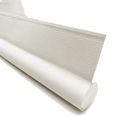 a close up view of a white mattress on a white background