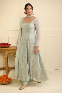 Ice blue georgette padded anarkali with floral, geometric stripe pattern chikankari thread embroidery, square neck, sequin and gota embellishment. Paired with semi crepe pant and embroidered dupatta.
Components: 3
Pattern: Embroidered and Embellished
Type Of Work: Chikankari, Sequin and Gota Work
Neckline: Square Neck
Sleeve Type: Full Sleeves
Fabric: Georgette, Pant: Semi Crepe, Lining: Semi Crepe
Color: Blue
Other Details: 
Piping details on neckline
Deep U back
Attached lining
Anarkali Closur Square Neck Anarkali, Anarkali Kurti Design, Suits For Women Indian, Anarkali Designs, Embroidery Square, Designer Anarkali Dresses, Long Frock Designs, Trendy Outfits Indian, Lehenga Designs Simple