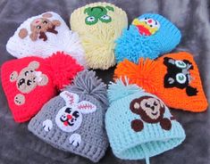 there are many knitted hats with animals on them