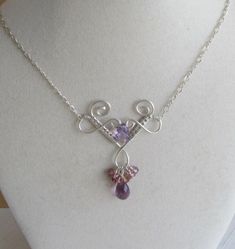 This delicate necklace is made of of woven silver wire. It features two beautiful amethysts and a cluster of lavender and pink sapphire rondelles.  It measures approx 19 inches long. Handmade Delicate Purple Necklace, Silver Amethyst Briolette Necklace, Purple Briolette Sterling Silver Necklace, Elegant Amethyst Wire Wrapped Necklaces, Pink Amethyst Wire Wrapped Jewelry, Elegant Wire Wrapped Amethyst Necklace, Elegant Amethyst Wire Wrapped Necklace, Elegant Purple Wire Wrapped Jewelry, Handmade Lavender Sterling Silver Necklace