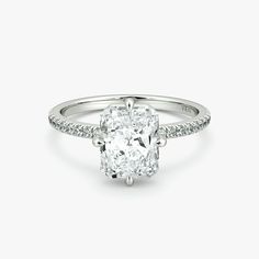 a cushion cut diamond ring with pave set shoulders