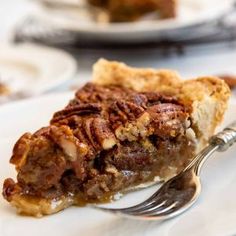 a slice of pecan pie on a plate with a fork