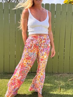 Ditch those boring trousers and upgrade to our Tulip Gardens beach pants! Featuring a flared leg and unique split tulip hem, these printed pants will have you turning heads. Made with 100% rayon for a comfortable and stylish fit. Get ready to stand out in these fun and playful pants! Casual Boho Print Pants For Vacation, Summer Vacation Boho Print Bottoms, Hippie Boho Print Vacation Bottoms, Summer Beach Boho Print Bottoms, Bohemian Floral Print Beach Bottoms, Bohemian Printed Bottoms For Beach Season, Bohemian Floral Beach Bottoms, Summer Floral Print Wide-leg Bottoms, Casual Boho Print Bottoms For Beach