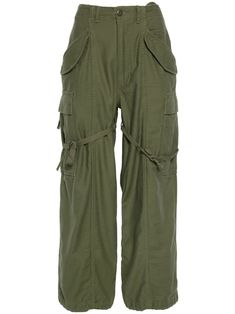 olive green cotton concealed zip-fly and button fastening belt loops two diagonal pockets to the sides two side flap pockets two side cargo pockets tie-fastening straps two rear flap pockets drawstring hem Khaki Military Style Parachute Pants, Olive Military Cargo Pants With Side Pockets, Military Olive Cargo Pants With Side Pockets, Utility Olive Parachute Pants With Pockets, Green Cotton Combat Cargo Pants, Khaki Combat Cargo Pants With Belt Loops, Combat Style Khaki Cargo Pants With Belt Loops, Green Combat Cotton Cargo Pants, Olive Military Cargo Pants With Multiple Pockets