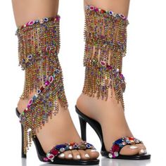 There’s Nothing Strange About Our Love For The Azalea Wang " Cascaded Gems " Embellished Sandal In Multi. These Glitzy Sandals Feature A Faux Leather Upper, An Open Almond Toe Silhouette, A Cushioned Faux Leather Insole, And A Slim Stiletto Heel. Complete With A Gemstone-Embellished Foot Band And A Coordinating, Rhinestone Link Fringe Trim Coiled Ankle Band. Pair With Distressed Denim For A Dose Of Casual Cool. - Faux Leather Upper - Open Almond Toe - Stiletto Heel - 3.75” Heel Height - 4.5” Spi Glamorous Rhinestone Beach Heels, Party Open Toe Sandals With Tassels, Party Sandals With Tassels And Open Toe, Party Open Toe Heels With Tassels, Party Heels With Tassels And Open Toe, Party Tassel Open Toe Heels, Chic Party Sandals With Tassels, Embellished Ankle Strap Sandals For Party Season, Chic Party Heels With Tassels