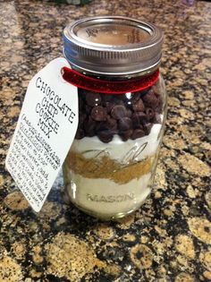 a jar filled with chocolate chip cookie mix on top of a granite counter next to a price label