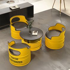 a table and chairs made out of yellow barrels