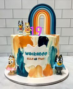 a birthday cake with cartoon characters on it